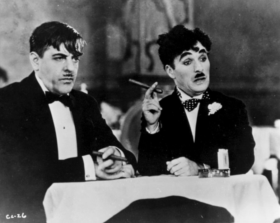 Charlie Chaplin and man dining
